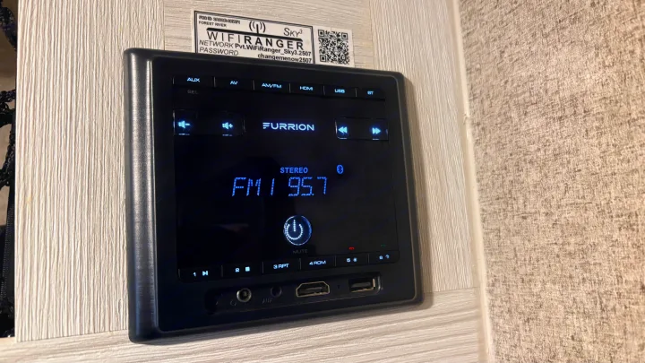 A Furrion stereo system in an **rv rental**, displaying FM 95.7. This audio unit provides various inputs like AUX, USB, and HDMI for entertainment.. Forest River Rockwood Geo Pro 2018