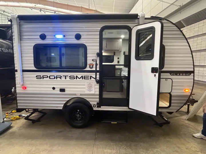 Compact Sportsmen Classic travel trailer with open door, perfect for an rv rental adventure and easy getaways.. K-Z 130RD 2026