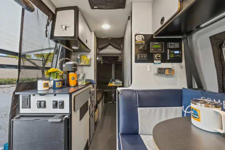 This RV rental offers a functional interior: kitchenette with Keurig, fridge, dinette, and control panel for an enjoyable journey.. Winnebago Revel 2023