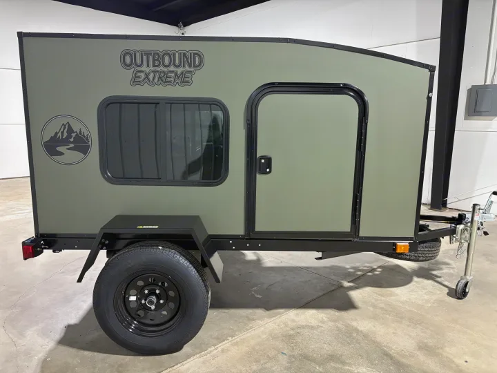 Olive green 'Outbound Extreme' compact camper trailer, ideal for RV rental and outdoor adventures.. Outbound Trailer Outbound Extreme 2026