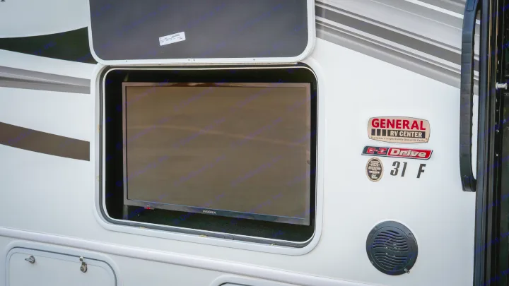 This RV rental features an Insignia TV in an exterior compartment, along with a speaker, for outdoor viewing.. Entegra Coach Odyssey 2023