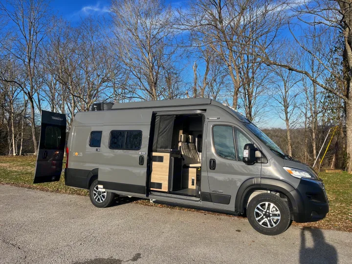 Gray Winnebago Solis camper van for RV rental, parked outdoors with doors open, showcasing its modern interior.. Winnebago Solis 2025