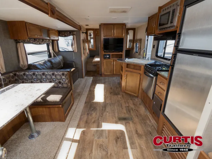 Bright, inviting RV rental interior with kitchen, dining booth, sofa, and entertainment for your trips.. Springdale sm2820bh16 2016