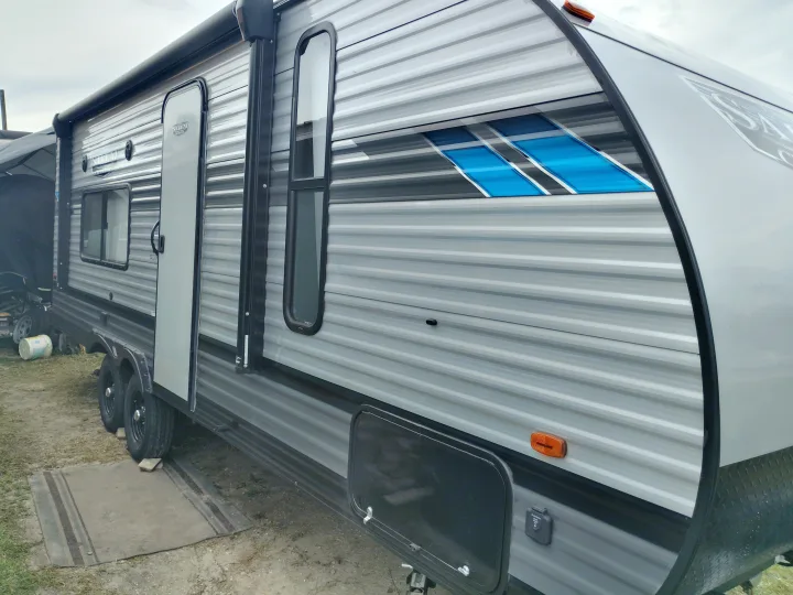 Experience comfortable rv rental travel with this stylish grey Salem Cruise Lite RV, featuring blue accents and an awning.. Forest River Salem Cruise Lite 2021