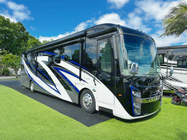 This stunning black and white Entegra Reatta luxury motorhome on green turf is ideal for your next upscale rv rental adventure.. Entegra Coach Reatta 2021