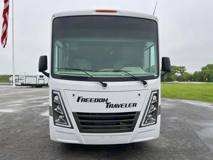 Front view of a white Freedom Traveler motorhome for rv rental, parked outdoors on a cloudy day.. Thor Freedom Traveler 2025