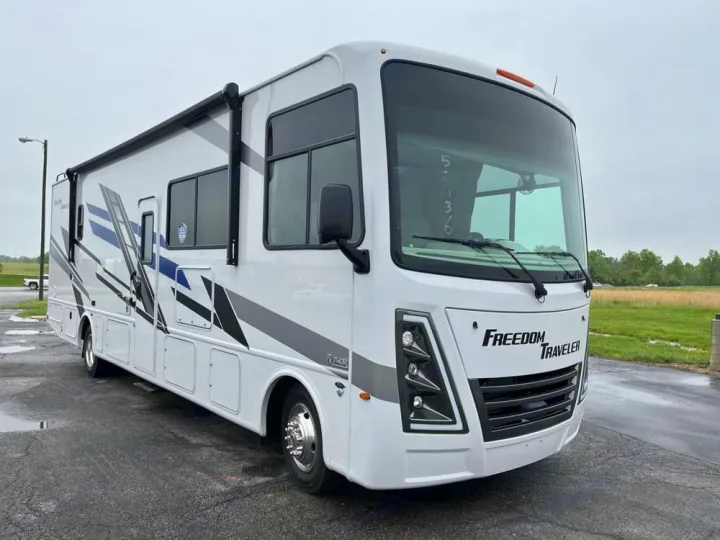 Modern white RV rental, a Freedom Traveler, parked outside on an overcast day.. Thor Freedom Traveler 2025