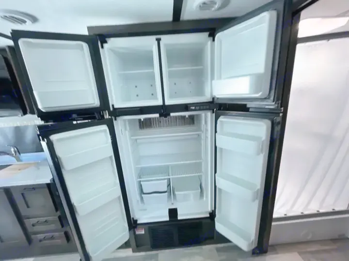 RV rental's spacious, empty four-door refrigerator and freezer, ready for your travel needs.. FR3 FR3 Motorhome 2024