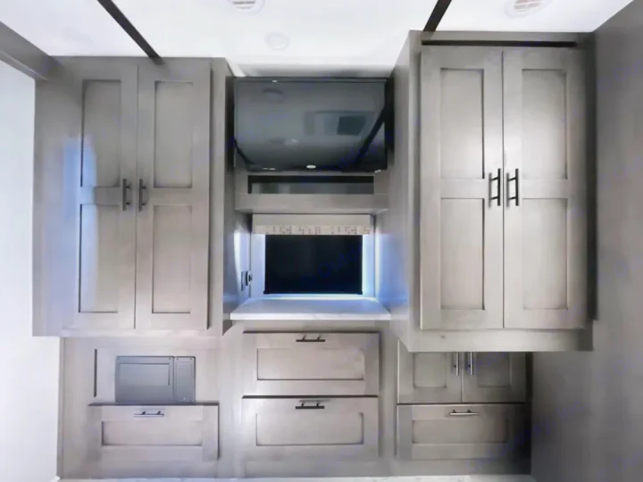 Stylish RV rental kitchen area features grey cabinets, an entertainment TV, microwave, and ample storage drawers.. FR3 FR3 Motorhome 2024