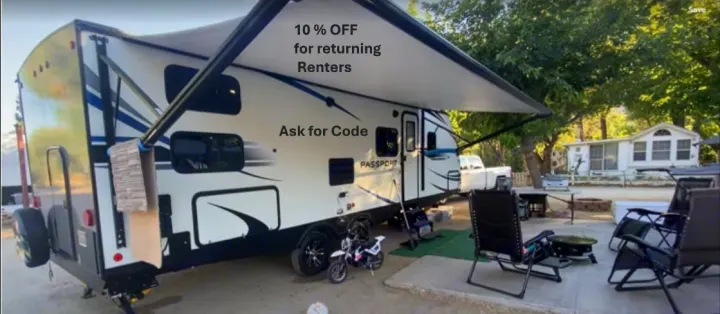 This RV rental at a scenic campsite offers 10% off for returning renters. Features an extended awning and outdoor seating.. Keystone RV Passport SL 2021