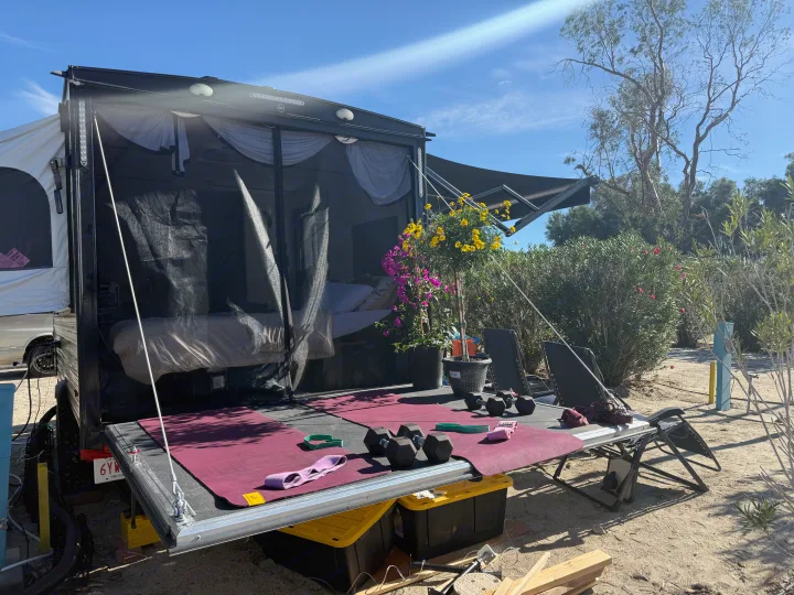 RV rental: Open ramp converts to an outdoor gym with dumbbells, mats, and a comfy bed peeking from inside.. Sun Lite 14 THX 2026