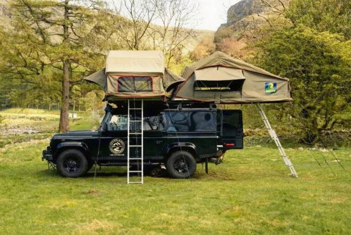 This rv rental is a black Land Rover Defender with dual rooftop tents, perfect for an overlanding adventure.. Land Rover Defender 110 XS Utility + 2 Roof Tents 2013