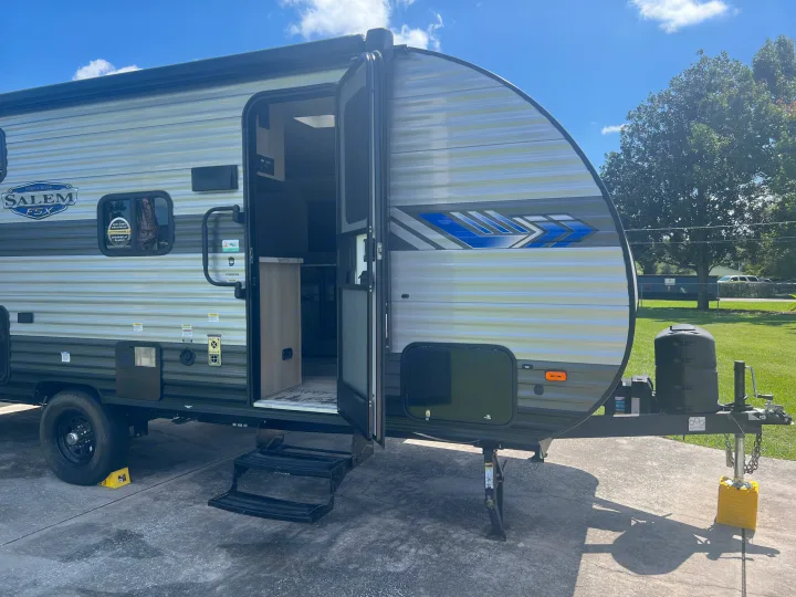 RV rental: A parked Forest River Salem FSX travel trailer with its door open, showing the exterior.. Forest River Salem FSX 2023