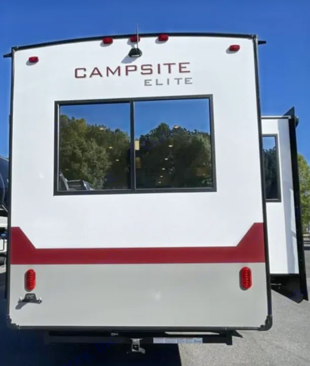 RV rental: Rear of white Campsite Elite travel trailer. Large window reflects trees; red & gray trim.. FOREST RIVER Campsite Elite 36RF 2026