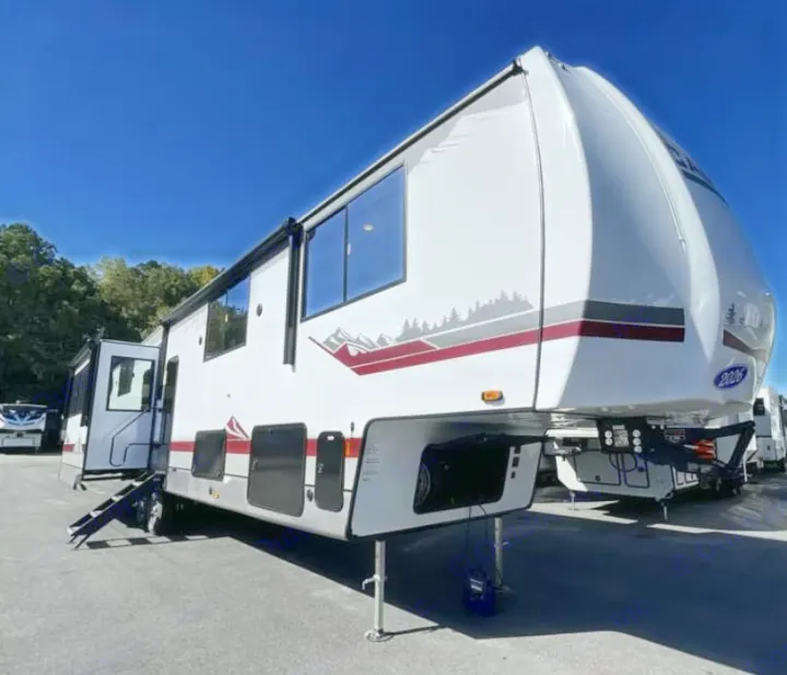 Spacious white fifth-wheel RV rental with nature-themed decals, ready for travel adventures under a clear sky.. FOREST RIVER Campsite Elite 36RF 2026