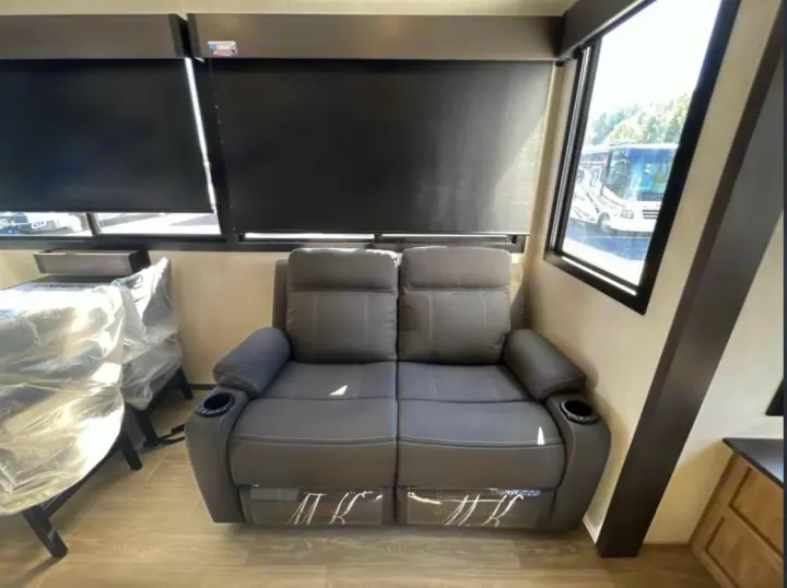 Cozy RV rental living area with gray recliner couch, cup holders, and blackout blinds for comfort on your trip.. FOREST RIVER Campsite Elite 36RF 2026