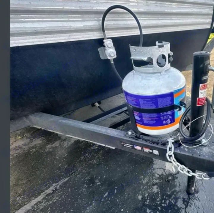 RV rental with a mounted propane tank, gas regulator, and hose connection, providing essential fuel for your trip.. Heartland RVs Prowler 2022