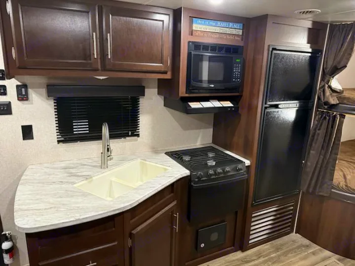 This RV rental offers a practical kitchen with a sink, stove, microwave, fridge, and cozy bunk beds, perfect for trips.. Jayco Jay Flight SLX Baja Edition 2019