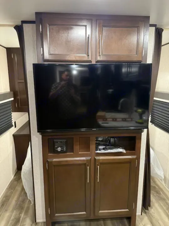RV rental: Wooden entertainment center with TV, stereo, and storage cabinets inside.. Jayco Jay Flight SLX Baja Edition 2019