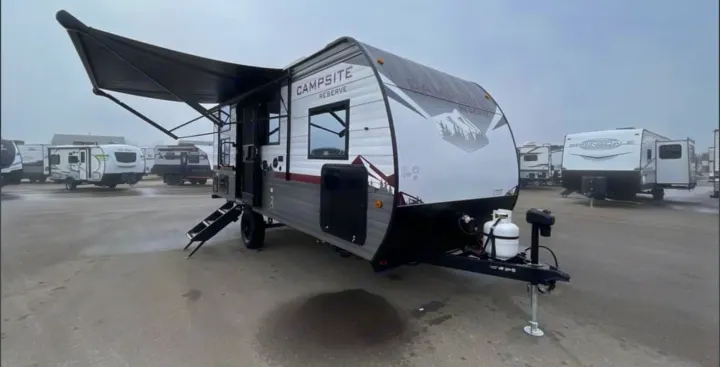 Campsite Reserve travel trailer RV rental with extended awning & steps in a dealer lot. Ready for outdoor adventures!. Forest River Campsite Reserve 17LS 2026