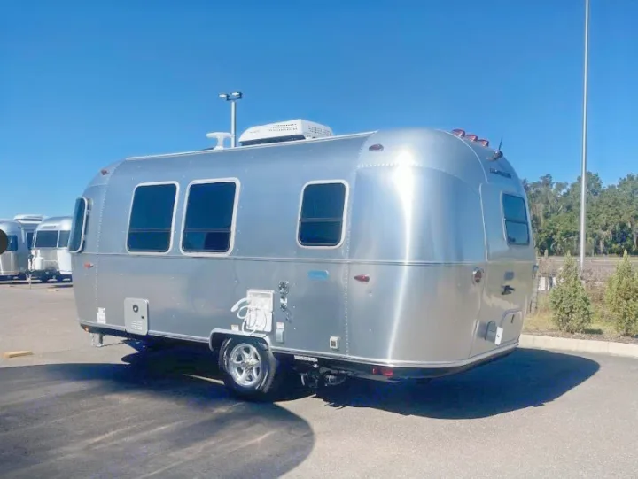 Modern silver Airstream travel trailer; consider this RV rental for your next camping vacation.. Airstream Bambi 2024