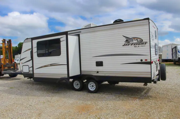 Jayco Jay Flight SLX travel trailer RV rental with extended slide-out, parked on gravel, ready for adventure.. Jayco Jay Flight SLX 2018