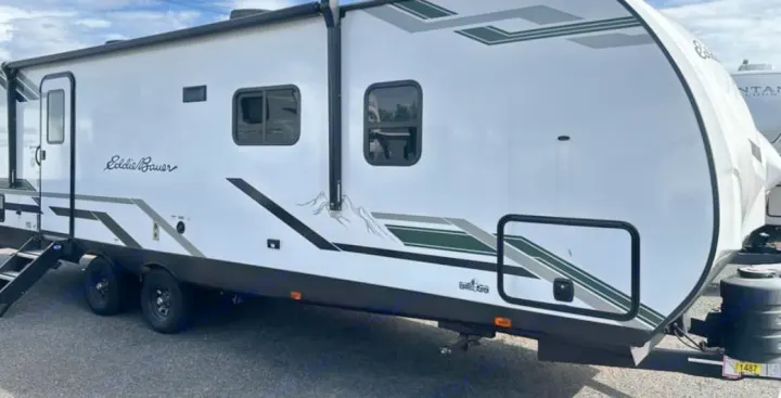 This Eddie Bauer RV rental features a stylish white exterior with mountain graphics, ready for your next adventure.. Keystone RV Flagstaff Super Lite 2023