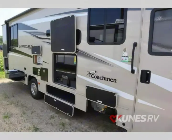 RV rental: Side of a Coachmen motorhome with several utility and storage compartments open, revealing inner workings.. Coachmen Leprechaun 2024