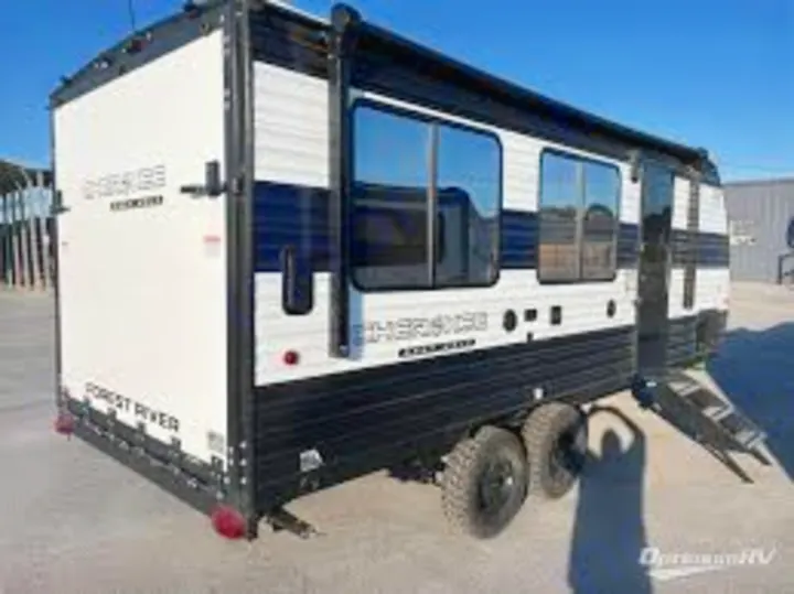 White & black Forest River Cherokee toy hauler RV rental, featuring rugged tires & a rear ramp. Ideal for adventure camping!. Forest River Cherokee Grey Wolf 2025