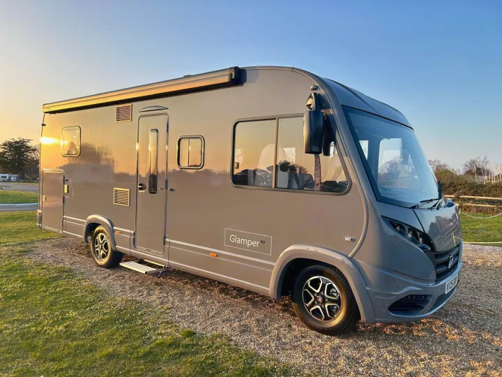 This stunning grey motorhome, a Glamper RV rental, shines in the sunset. Ideal for your next campervan or glamping adventure.. GlamperRV DBL 2026