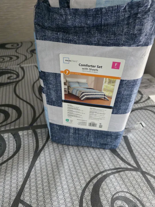 Packaged Mainstays Full-size comforter and sheet set with blue/white stripes, ready for an RV rental.. Keystone RV Hideout 2025