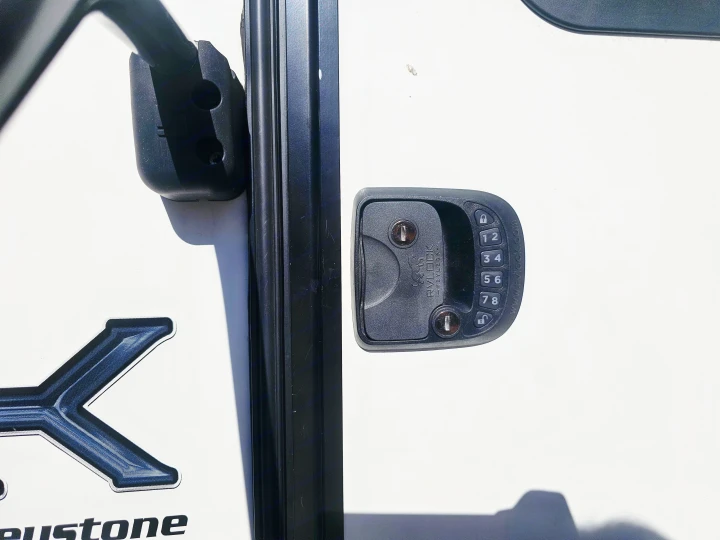 RV rental door with an RVLOCK keyless entry system: keypad, keyholes, and lock/unlock buttons for secure access.. Keystone RV Outback Ultra-Lite 2021