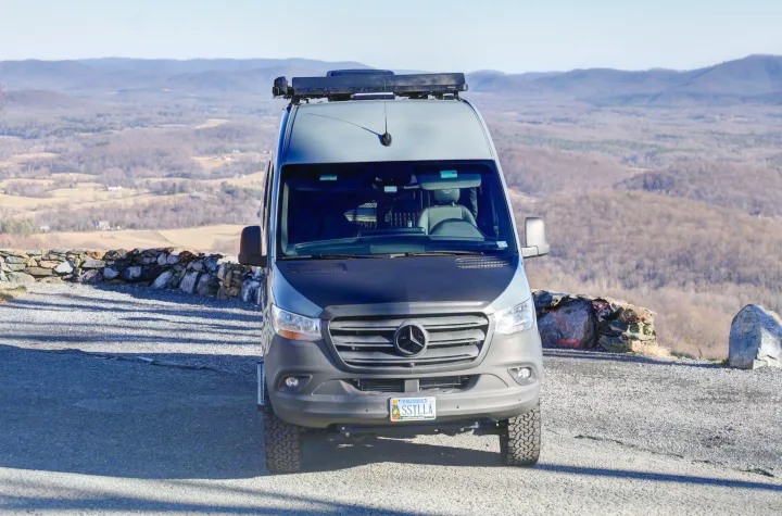 Grey Mercedes Sprinter rv rental parked at a mountain overlook, surrounded by vast, bare-tree landscapes.. Mercedes-Benz Sprinter 2021