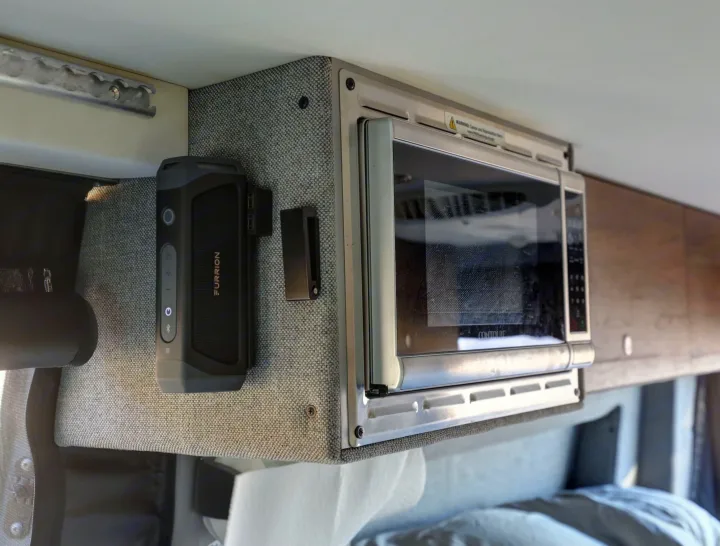 RV rental interior features: a Furrion speaker & Contoure microwave, providing amenities for your journey's comfort.. Mercedes-Benz Sprinter 2021