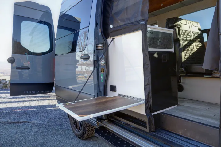 Explore this RV rental: an open Storyteller Overland van with an outdoor side table, ideal for cooking & adventure on the go.. Mercedes-Benz Sprinter 2021