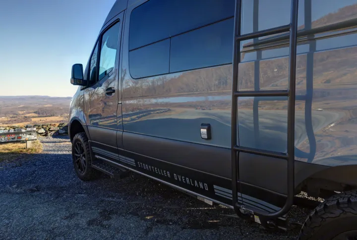 This Storyteller Overland adventure van, an ideal rv rental, is parked at a scenic mountain overlook, ready for travels & views.. Mercedes-Benz Sprinter 2021