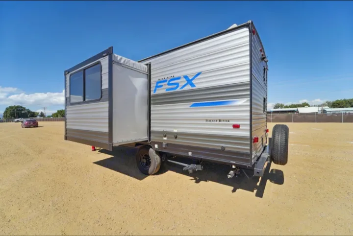 Explore the outdoors with this Salem FSX travel trailer. Ideal for an RV rental, featuring an extended slide-out and spare tire.. Forest River Salem FSX 2021