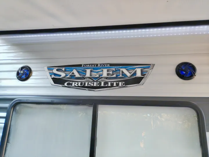 Forest River Salem Cruise Lite RV rental exterior with logo, blue LED speakers, awning light strip, and frosted window. Adventure awaits!. Forest River Salem Cruise Lite 2021
