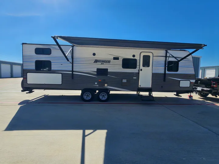 Avenger travel trailer rv rental with extended awning, parked in a sunny lot. Ready for your next adventure!. Avenger ATI 2019