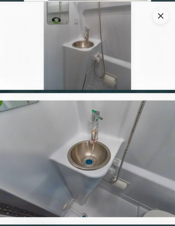 RV rental's compact bathroom: an integrated sink, faucet/shower head, and toilet. Efficient, all-in-one design for small spaces.. Thor Tranquility 2025