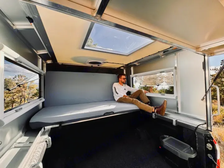 Relax in this RV rental truck camper with panoramic views & portable power. Ideal for outdoor adventures and comfortable stays.. Chevrolet Silverado 1500 Trail Boss 2020
