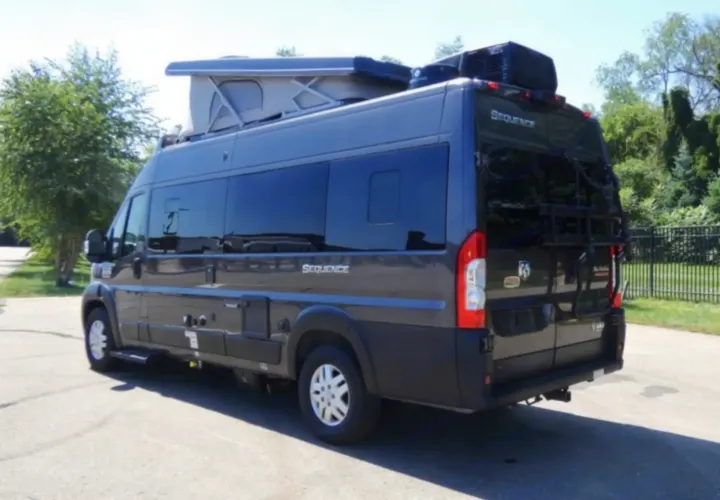 This dark gray pop-top camper van is perfect for your next RV rental adventure, equipped with roof AC and a rear rack.. Thor Sequence 2022