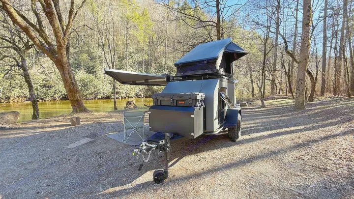 Adventure awaits with this compact overland trailer RV rental by a serene river. Perfect for off-grid camping in nature!. Cedar Ridge Deneb XT 2025