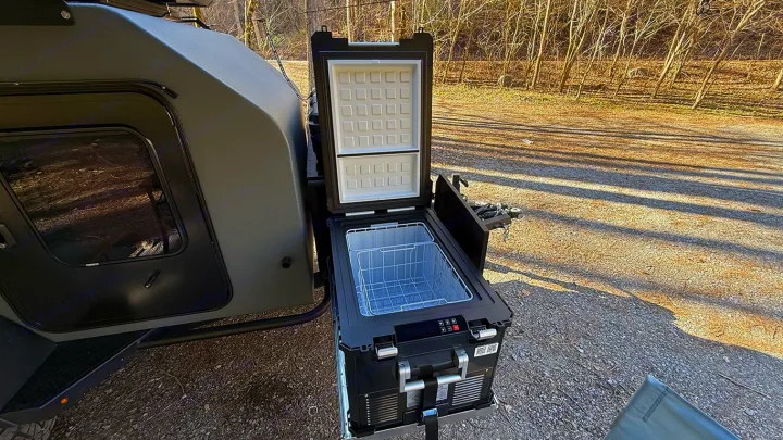 This RV rental features a pull-out portable fridge/freezer, perfect for camping and outdoor adventures with the trailer.. Cedar Ridge Deneb XT 2025