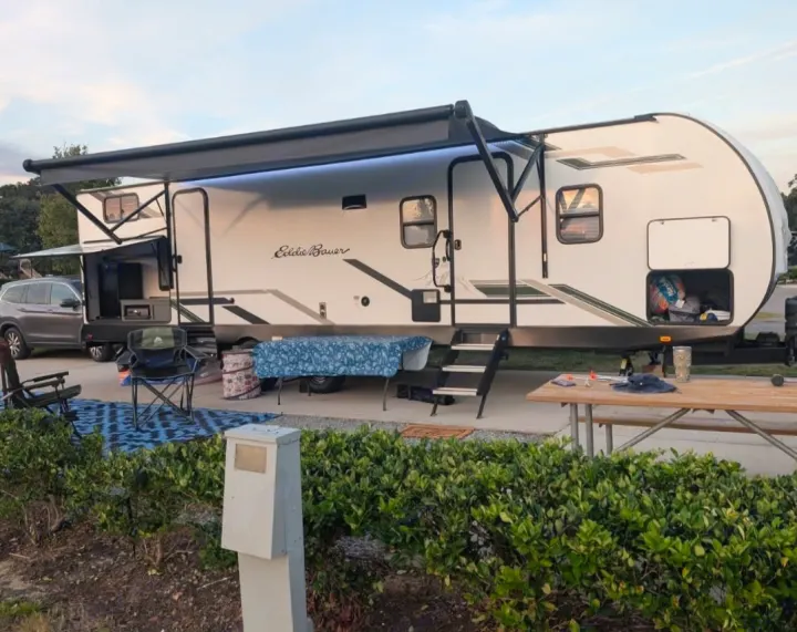 Enjoy a relaxing evening at a fully set up campsite with an Eddie Bauer travel trailer, perfect for an RV rental adventure.. Eddie Bauer Eddie Bauer 2024