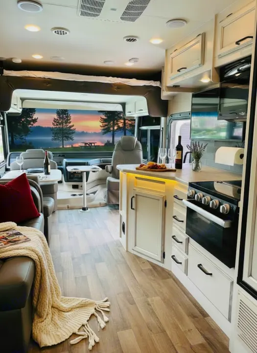 Enjoy luxury rv rental travel! This motorhome interior boasts a cozy living space, fully equipped kitchen, and stunning lake view.. Jayco Alante 2021