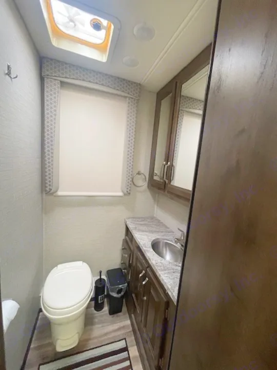 This RV rental bathroom offers a compact design with toilet, sink, mirror, and window. Efficient and well-lit for your travels.. Jayco Greyhawk 2019