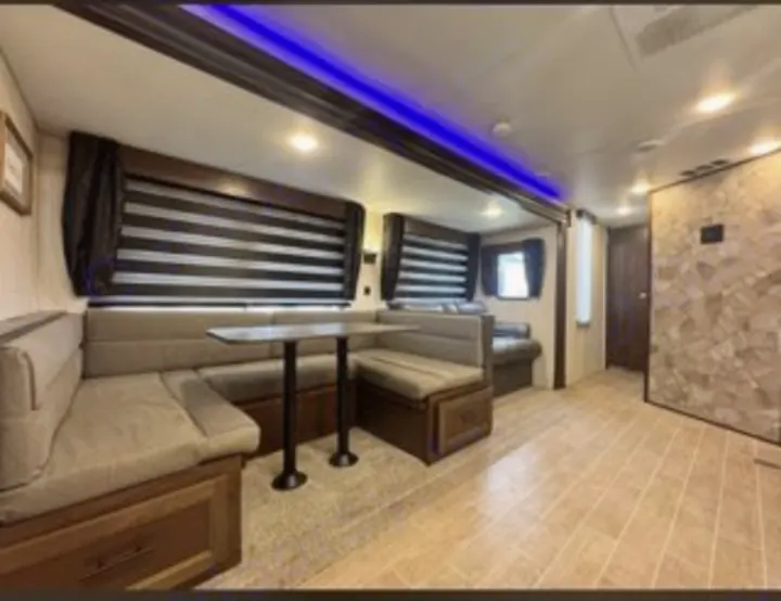 Experience comfort in this RV rental's modern interior. Features a spacious dinette with U-shaped seating & stylish lighting.. Forest River Cherokee 2020