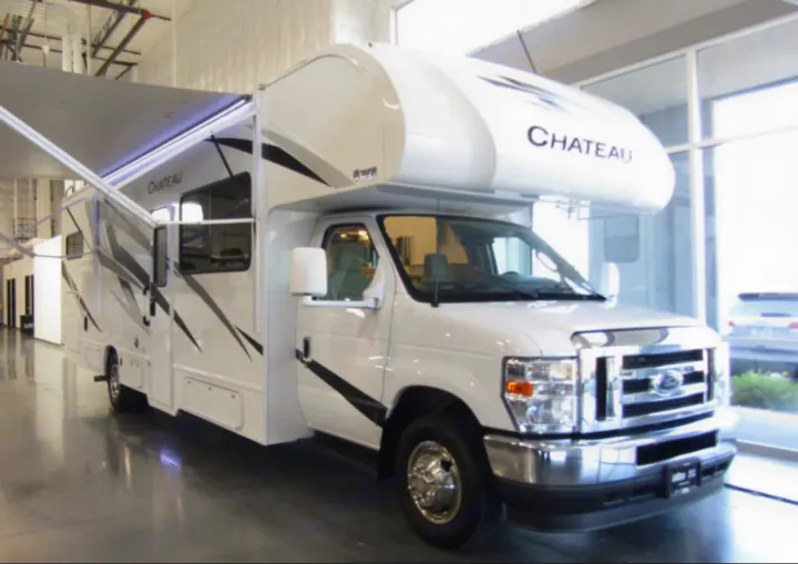 White Chateau Class C RV with an extended awning, ideal for your next rv rental adventure.. Thor Chateau 2024