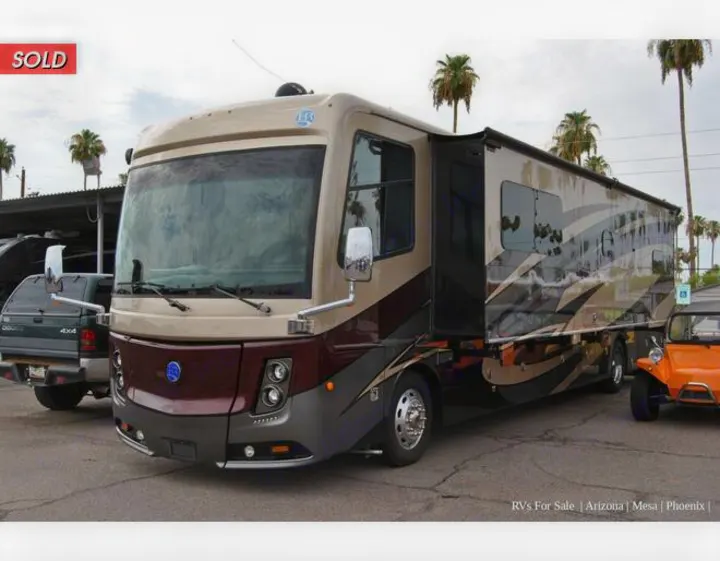 A large, beige & brown Class A motorhome (SOLD) with an extended awning. Perfect for luxury RV rental adventures.. Holiday Rambler Endeavor 2018